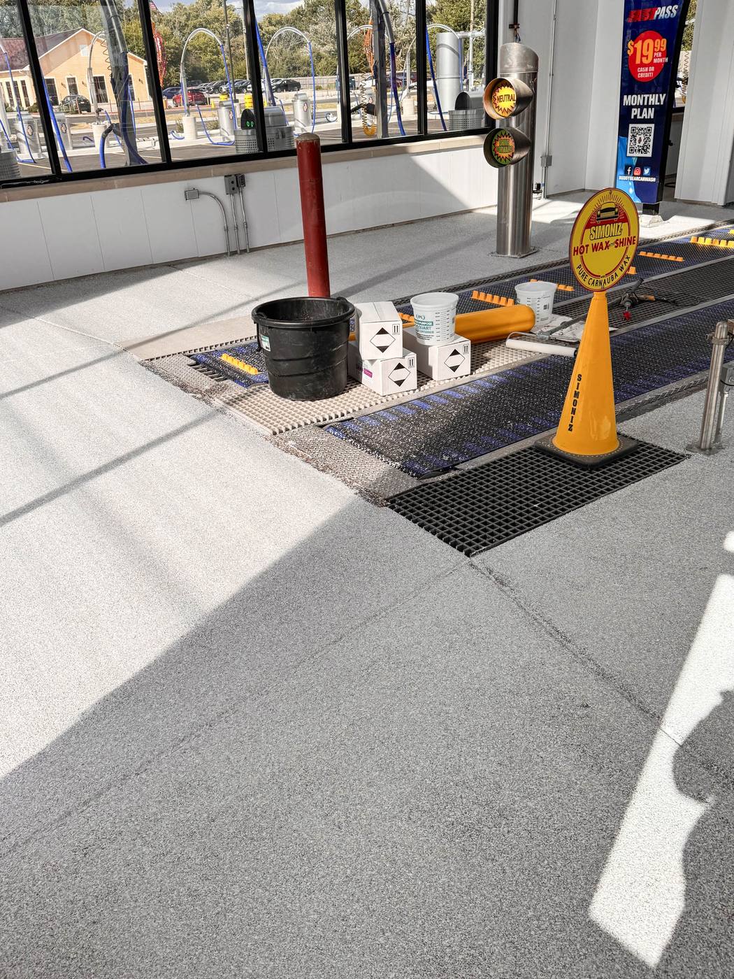 Coated car wash bay floor