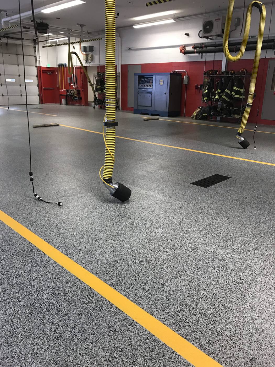 Coated firehouse apparatus bay floor